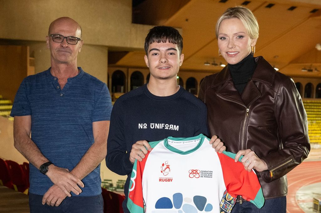 charlene posing with young rugby player