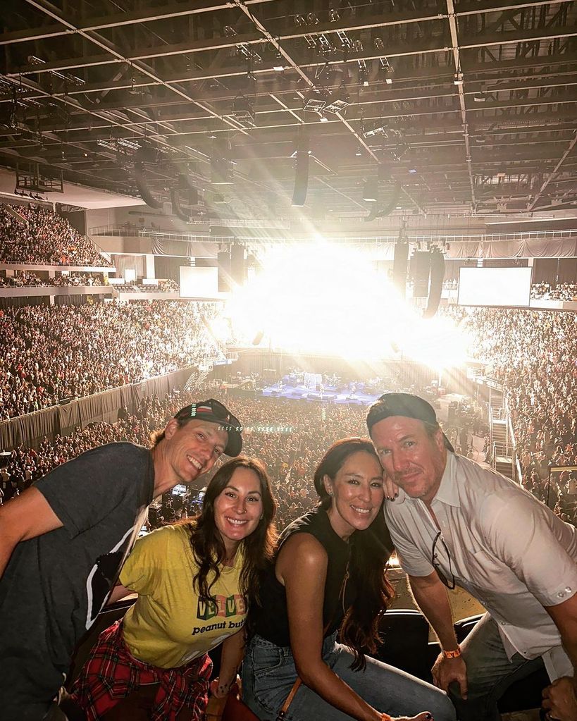 Chip and Joanna Gaines posing with friends at a concert