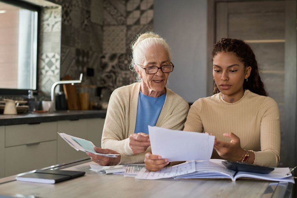 older woman speaking with daughter about documents