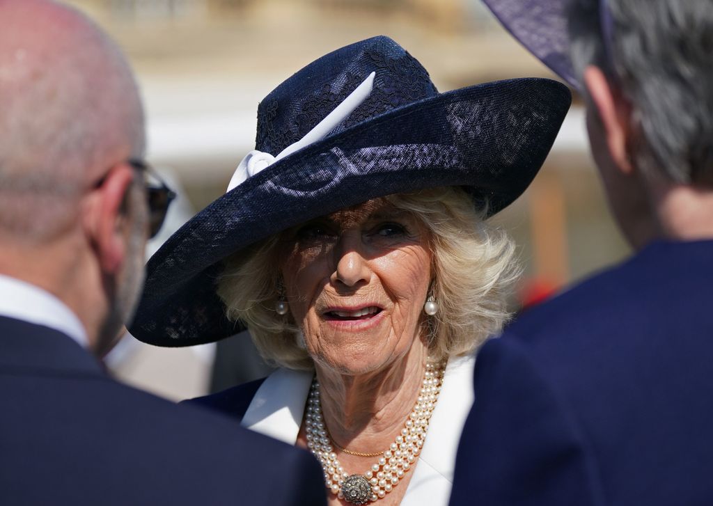 queen camilla in a Stephen Jones hat 