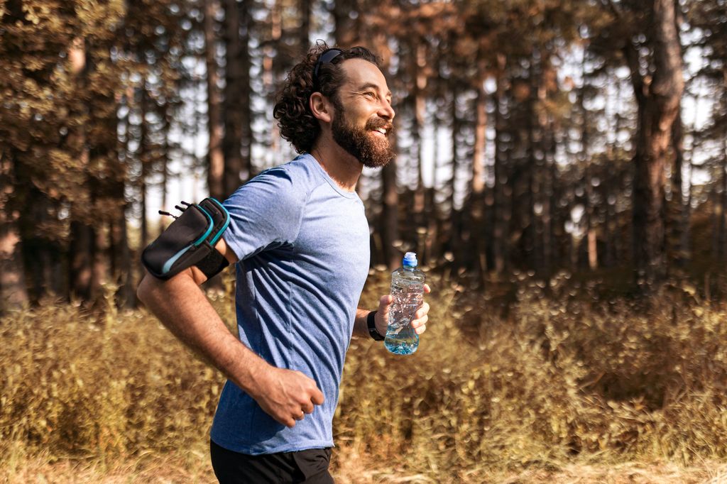 Man Jogging Through Serene Forest Trail