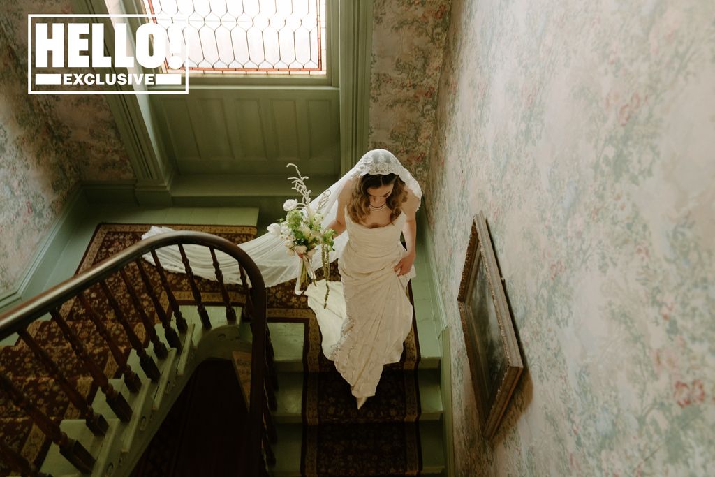 Tessa Mossey walks down the stairs in her wedding gown