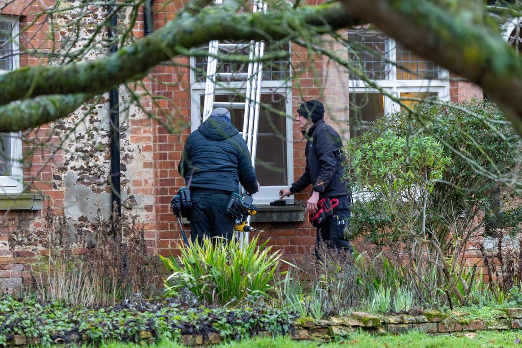 workmen outside house with ladder