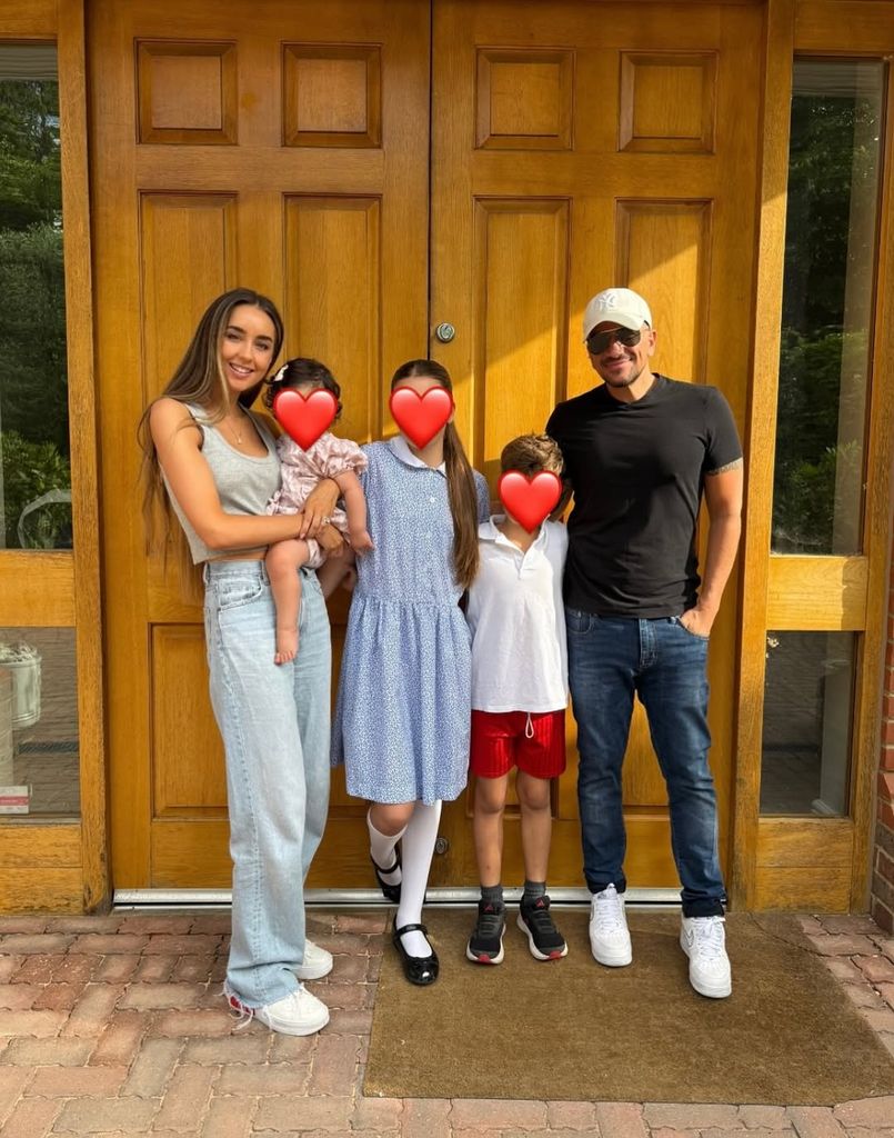 A family photo of Peter and Emily Andre with their three children, whose faces are blocked out by heart emojis