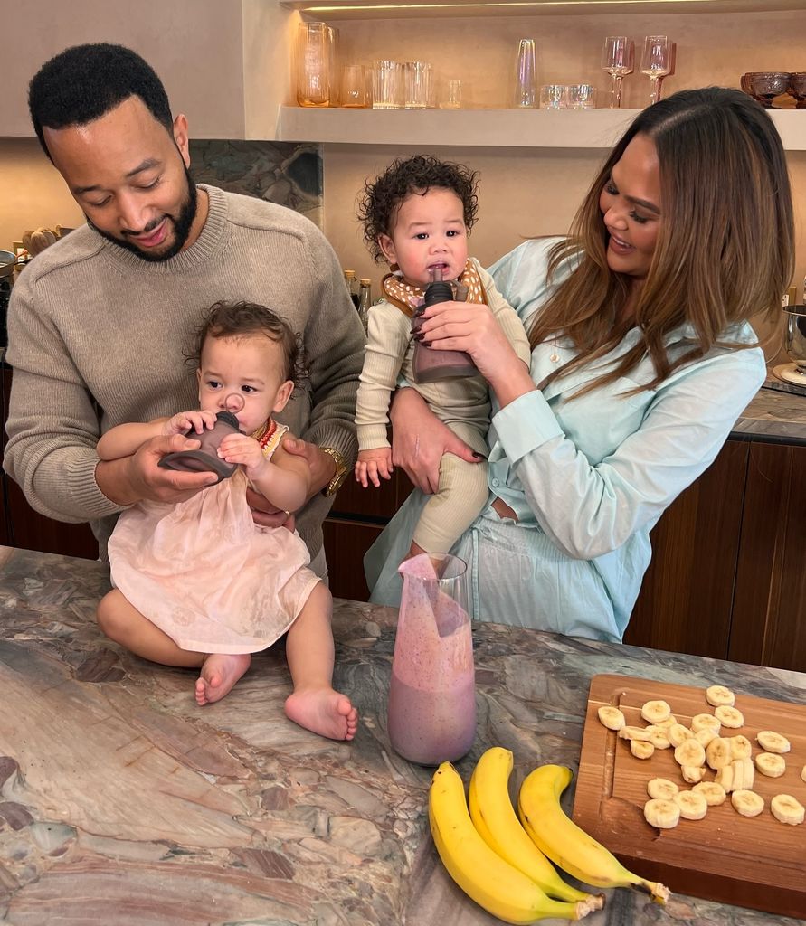 Chrissy in her kitchen with john and her kids