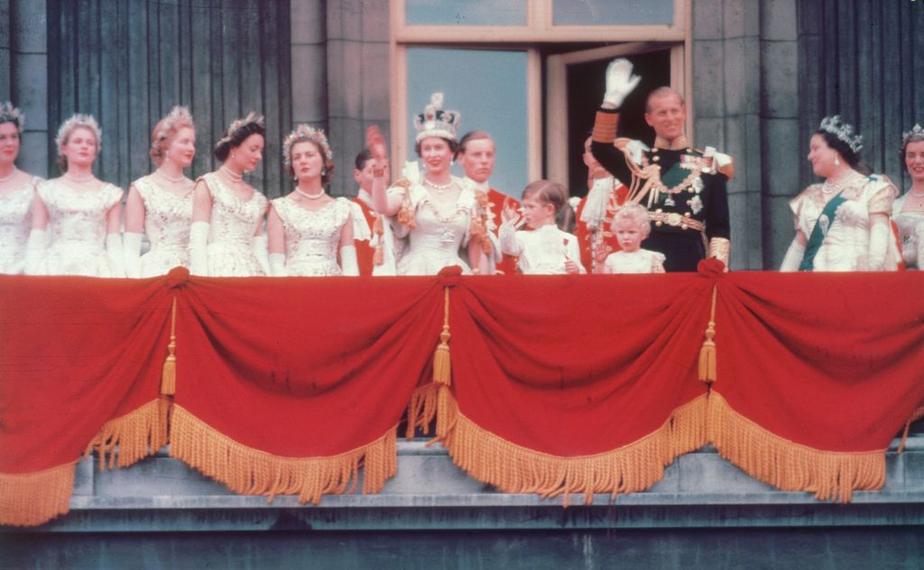 The Queen and Prince Philip wave on Buckingham Palace
