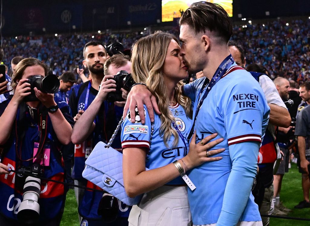 Manchester City's English midfielder #10 Jack Grealish celebrates with his girlfriend Sasha Attwood after winning the UEFA Champions League final football match between Inter Milan and Manchester City at the Ataturk Olympic Stadium in Istanbul, on June 10, 2023