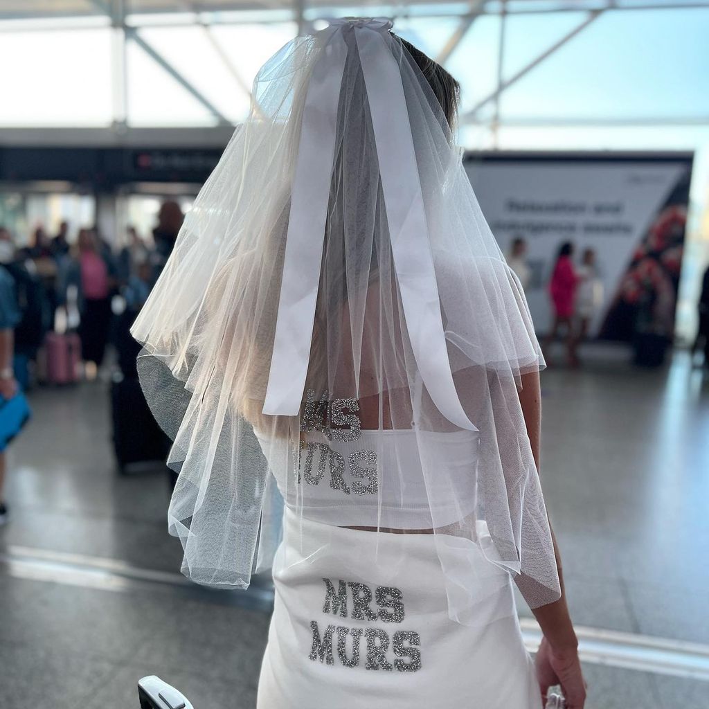 Amelia wearing a personalised veil in airport