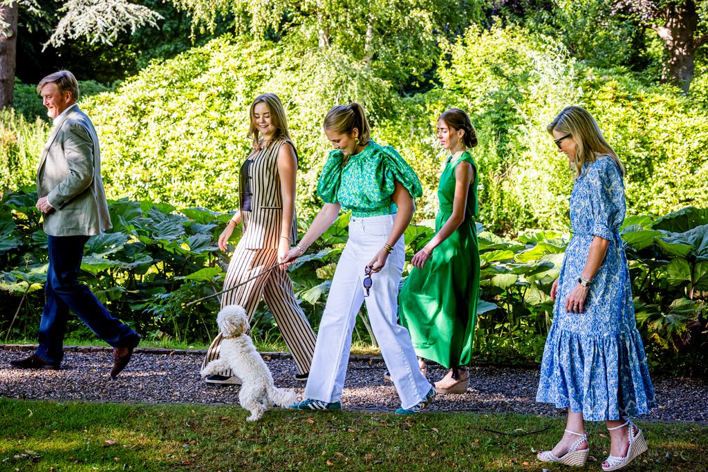 Queen Maxima walking the dog with her family