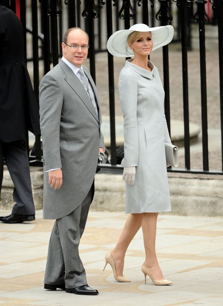 Prince Albert II of Monaco in a grey tailcoat with Princess Charlene in a grey coat dress