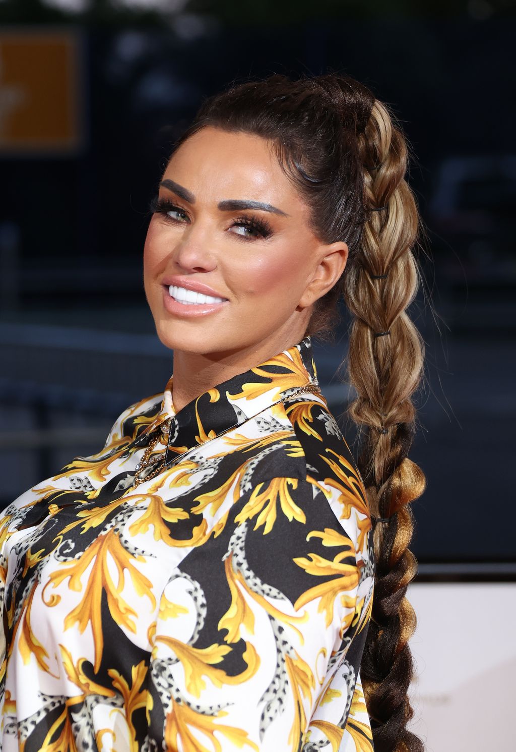Katie Prices smiling for a photo at a red carpet event