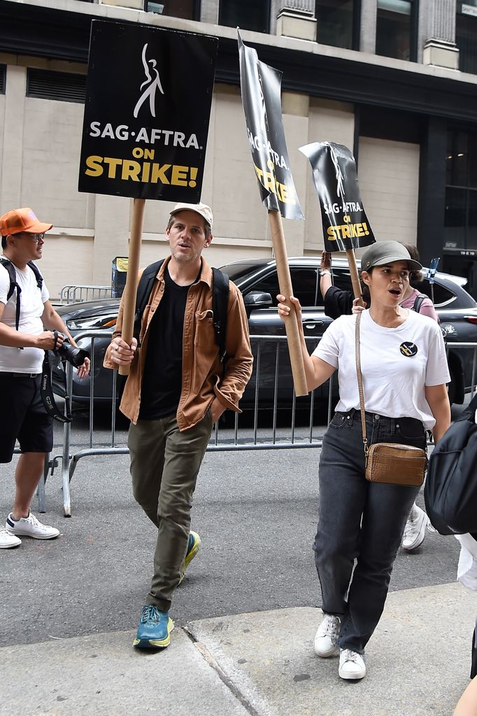 America Ferrera and Ryan Piers Williams walk the picket line in support of the SAG-AFTRA and WGA strike on July 19, 2023 in New York City