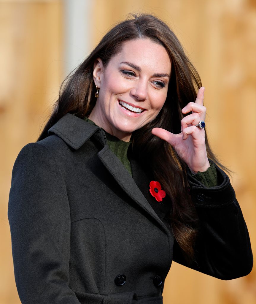 Kate Middleton adjusting her hair at Colham Manor Children's Centre 