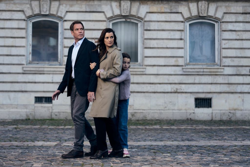 father, mother, daughter standing in street
