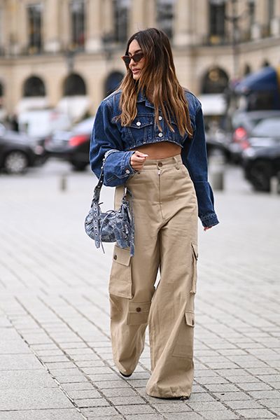 Woman wearing denim jacket with cargo trousers