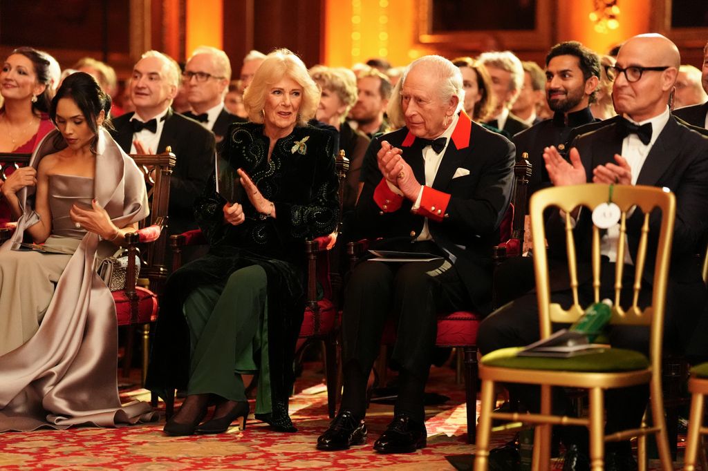 Britain's King Charles III and Britain's Queen Camilla applaud during the premiere of Prime Video's Finding Harmony: A King's Vision, at Windsor Castle in Windsor, on January 28, 2026. (Photo by Jonathan Brady / POOL / AFP via Getty Images)