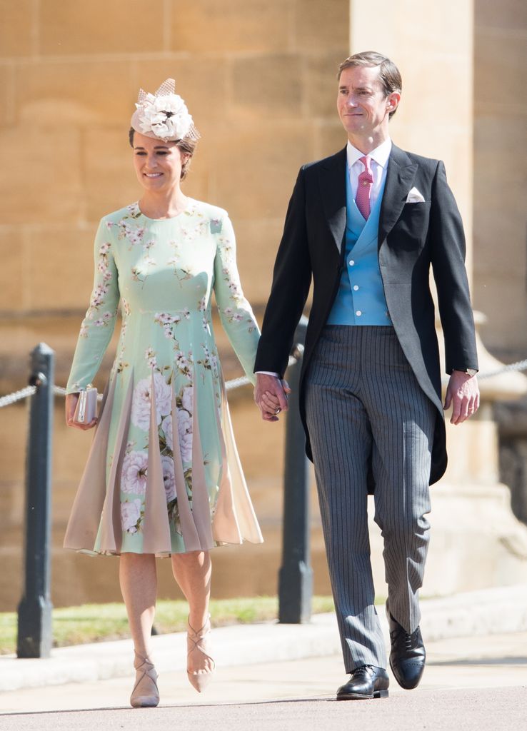 Pippa Middleton in a green floral dress holding hands with James Matthews