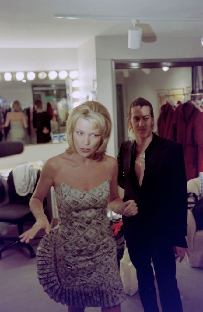 Designer Jeremy Scott styles television host Vanna White in his cloth money dress, 2001