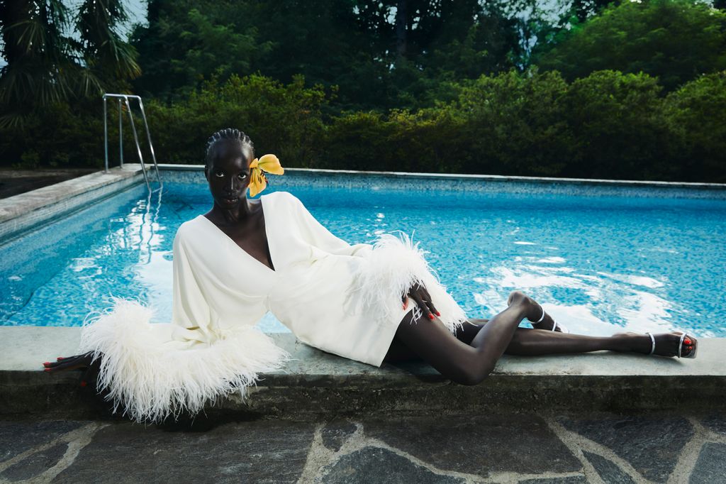 Model wears white feather-trim Taller Marmo SS25 dress