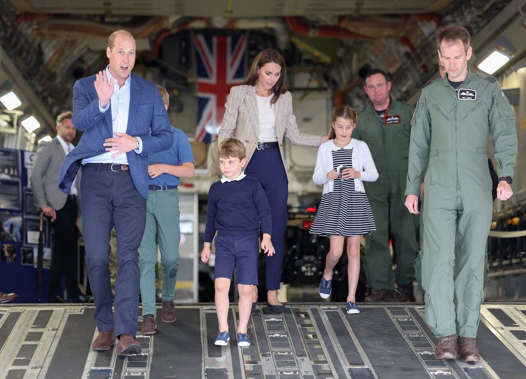 Prince William, Prince of Wales and Catherine, Princess of Wales with Prince George of Wales, Princess Charlotte of Wales and Prince Louis of Wales walk down the ramp of a C17 plane during their visit to the Air Tattoo at RAF Fairford 