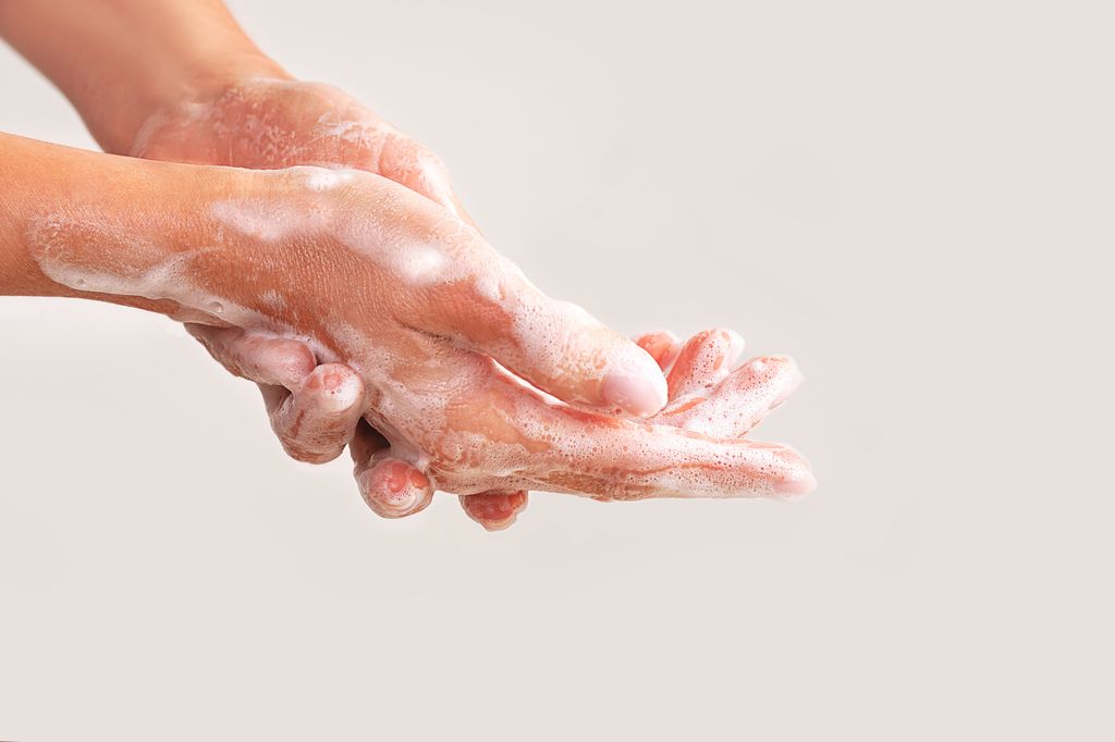 hands with soap or cosmetic milk or washing foam