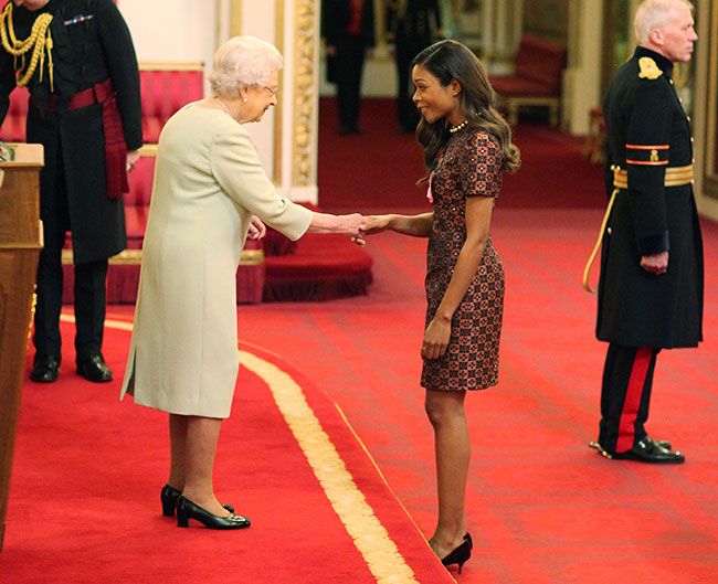 Naomie Harris looks delighted as she receives OBE from the Queen | HELLO!