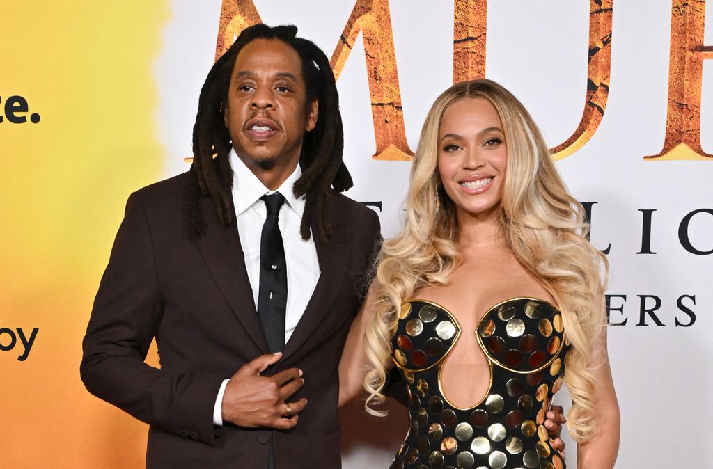 Jay-Z and US singer-songwriter Beyonce smiling with arms around eachother at the world premiere of Disney's "Mufasa: The Lion King''