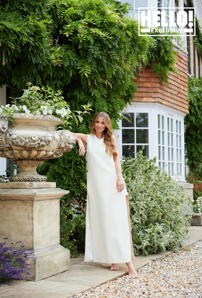 Yoanna Hanbury posing outside Berkshire home in white maxi dress