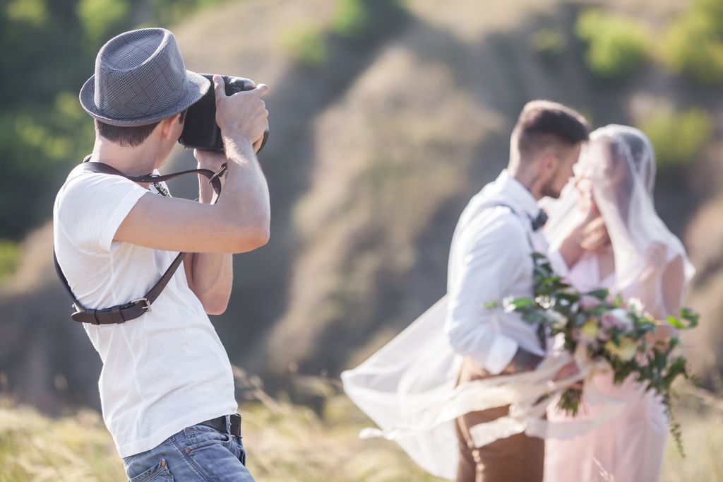 a wedding photographer takes pictures of the bride and groom