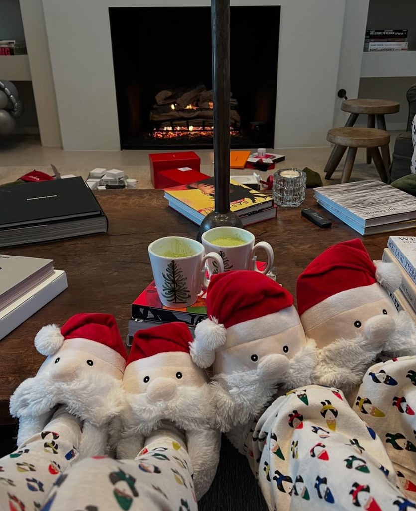 Photo shared by Kourtney Kardashian on Instagram ahead of Christmas of her and her husband Travis in Christmas pajamas and Santa Claus slippers