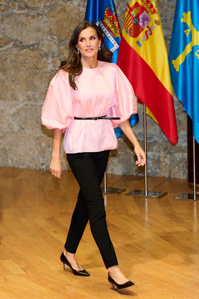 Queen Letizia of Spain in pink top and black trousers