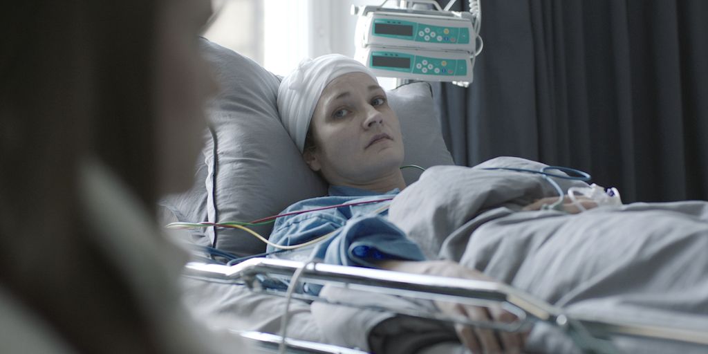 woman lying in hospital bed