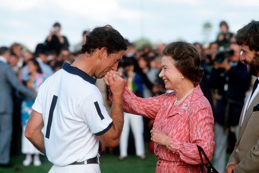 Charles kisses Queen's hand at polo