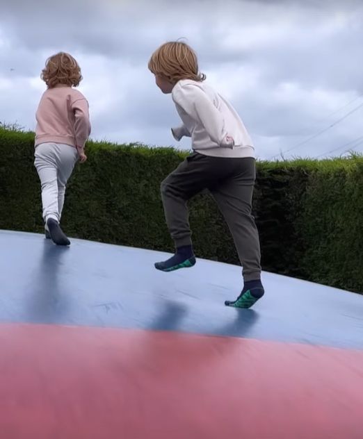 Two children playing on an inflatable