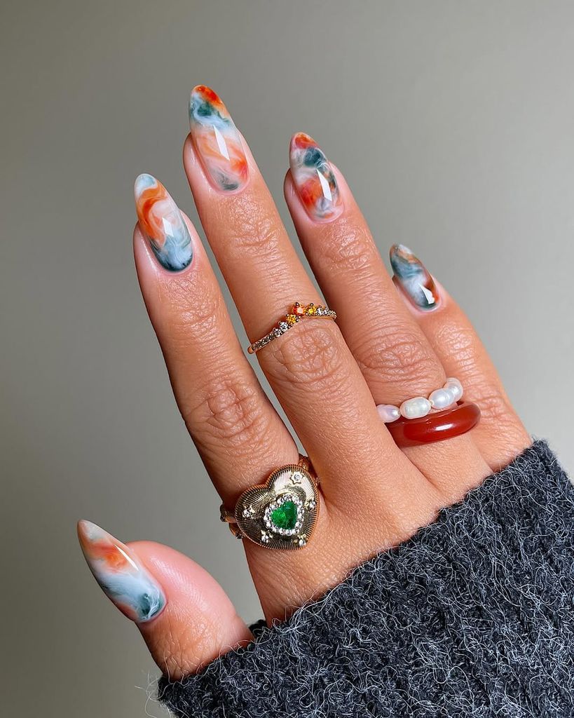 marble orange blue nails close up