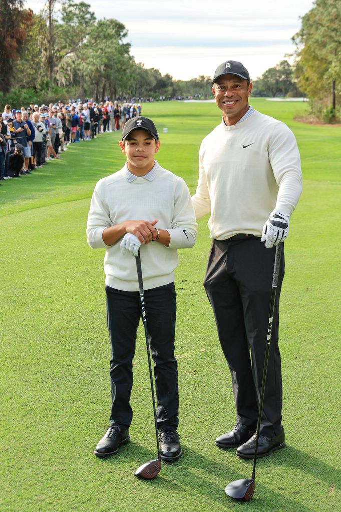 Tiger Woods of The United States poses with his son Charlie Woods on the first tee during the Friday pro-am as a preview for the 2022 PNC Championship at The Ritz-Carlton Golf Club on December 16, 2022 in Orlando, Florida. 