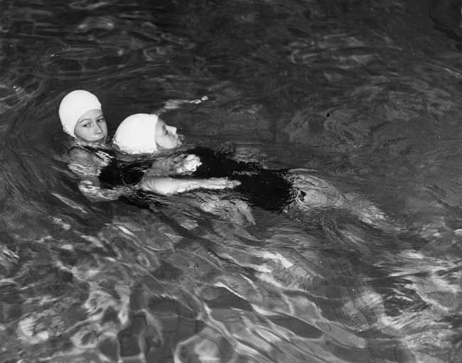 the queen swimming in a swimming hat during childhood