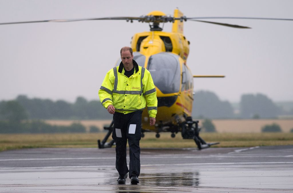 Prince William walking away from an air ambulance