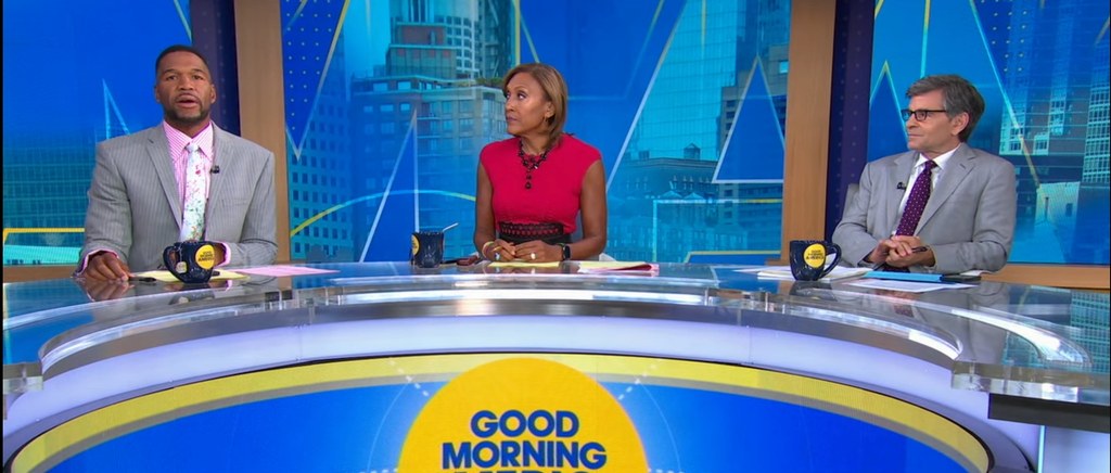 Michael Strahan, Robin Roberts and George Stephanopoulos sit at the GMA desk