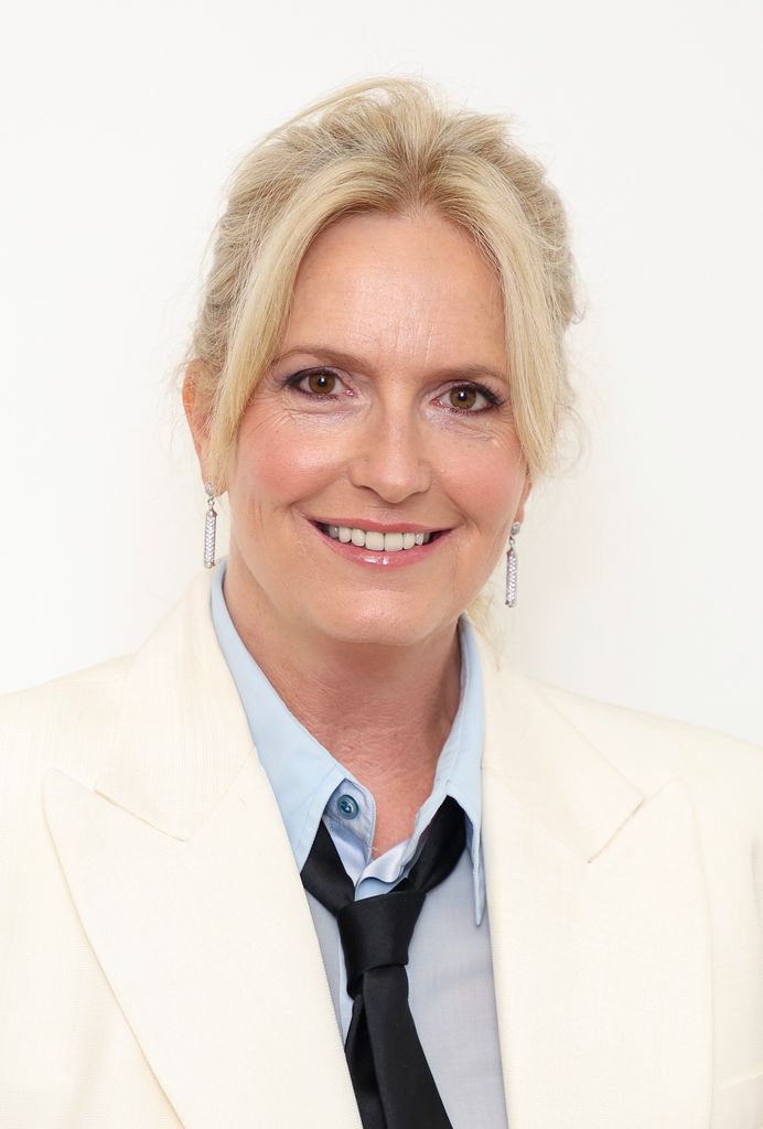 Penny Lancaster close up in suit look with ponytail and glowing makeup