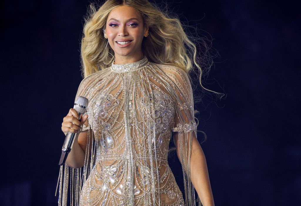 Beyonce smiling in a glittery bodysuit