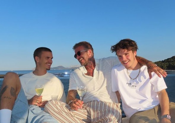 father with two sons on boat