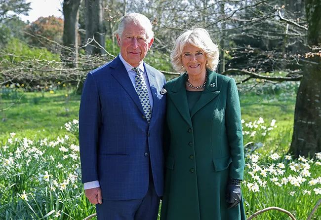 charles and camilla smiling in garden