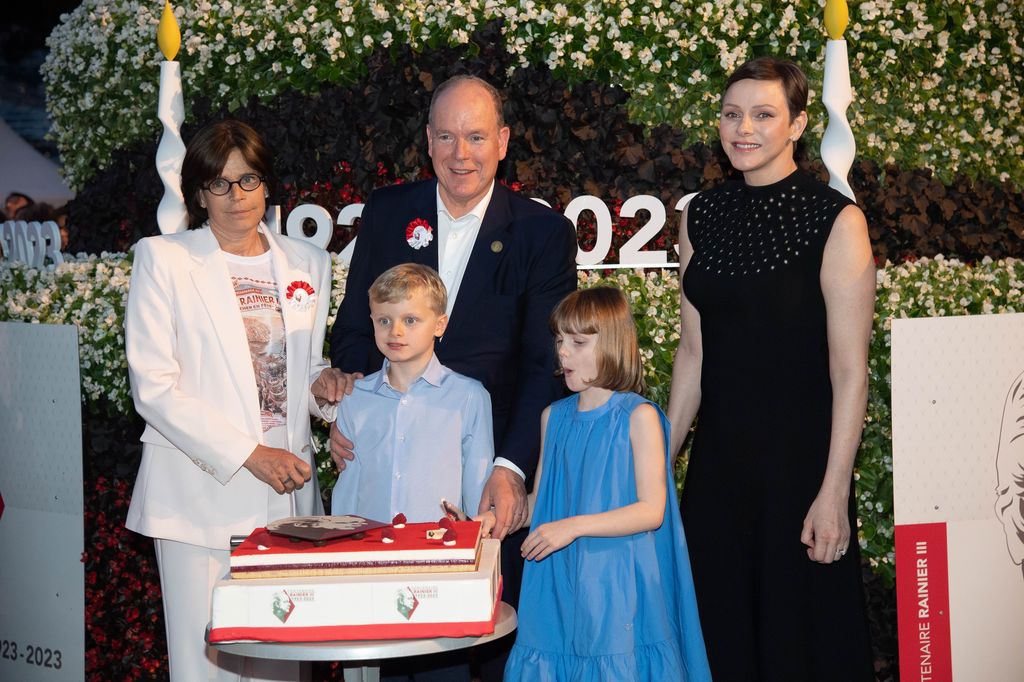 Princess Stephanie of Monaco, Prince Jacques of Monaco, Prince Albert II of Monaco, Princess Gabriella of Monaco and Princess Charlene of Monaco cutting a cake