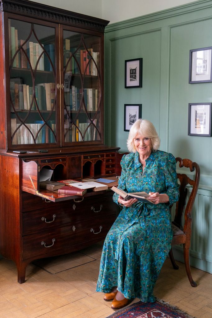Queen Camilla in front of bookcase in Rye