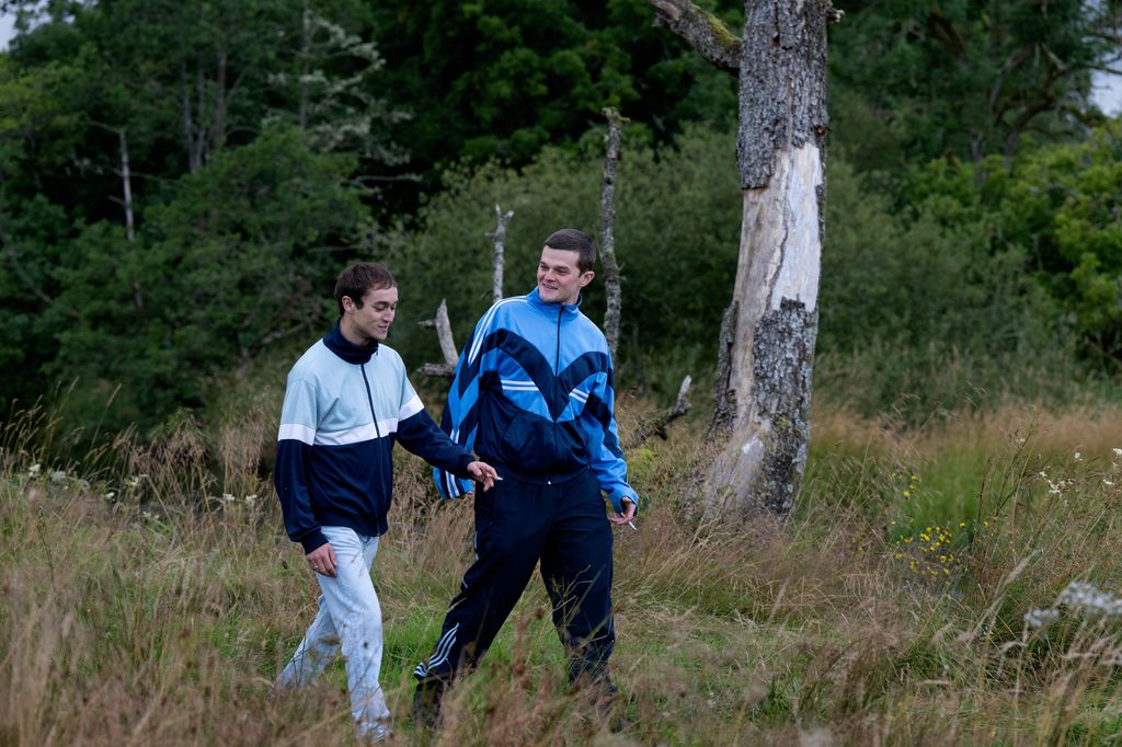Still from I Swear Studiocanal film showing teen John Davidson with pal walking through field