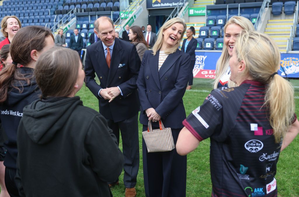 Sophie laughing talking to rugby players