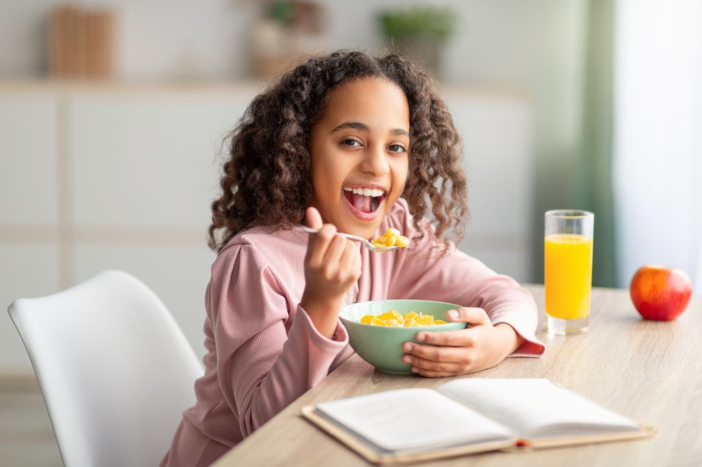 Young girl eats breakfast