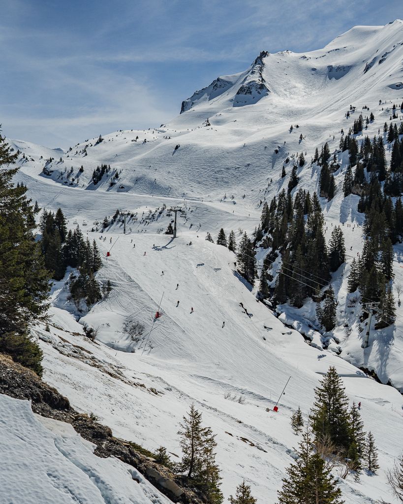 Skiers down a slope on a mountain