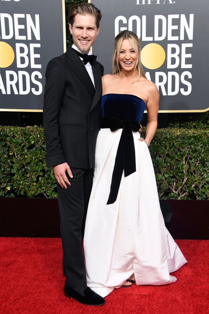Karl Cook in a black suit and Kaley Cuoco in a blue and white gownin 2019 